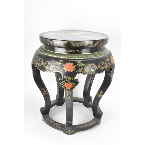 131 - A Chinese 20th century occasional table, having a black lacquered frame supported by five curved cab... 