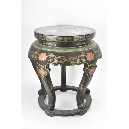 131 - A Chinese 20th century occasional table, having a black lacquered frame supported by five curved cab... 