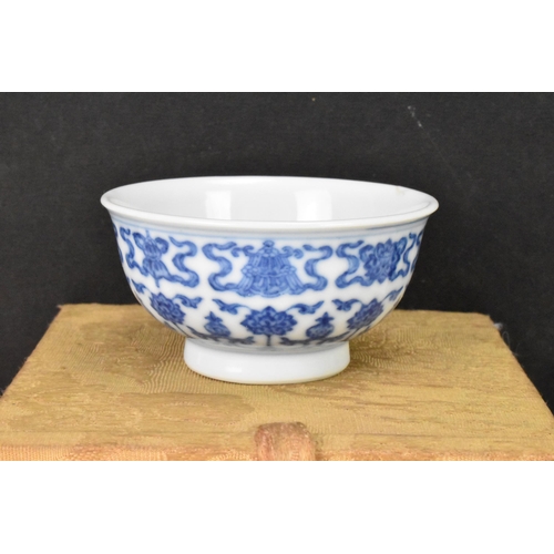 137 - A Chinese blue and white tea bowl, decorated with lotus flowers among stylized scroll decoration wit... 