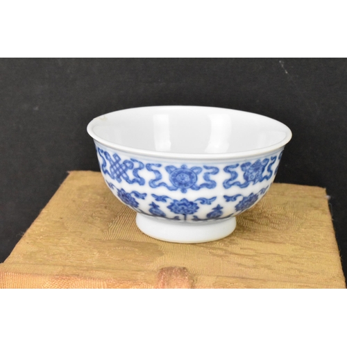 137 - A Chinese blue and white tea bowl, decorated with lotus flowers among stylized scroll decoration wit... 