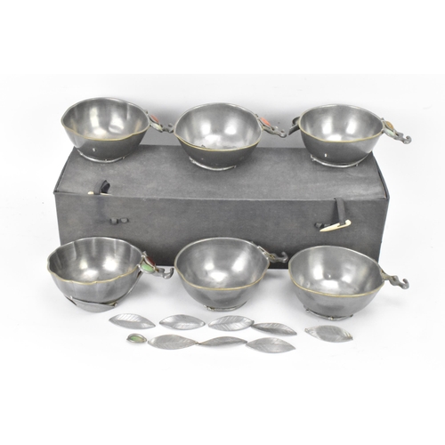 144 - A set of six Chinese pewter bowls, each having a shaped rim and fluted body, the handles in the form... 