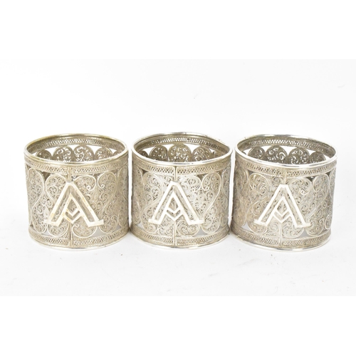 149 - A set of six early 20th century Middle Eastern white metal filigree napkin rings, elaborately pierce... 