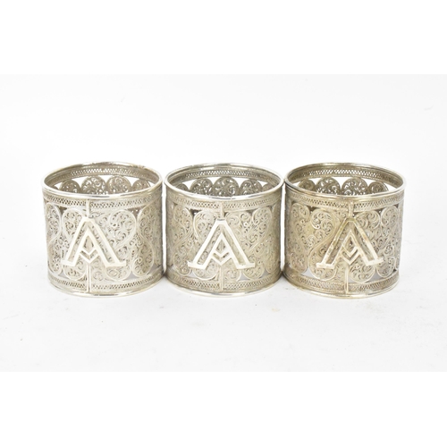 149 - A set of six early 20th century Middle Eastern white metal filigree napkin rings, elaborately pierce... 