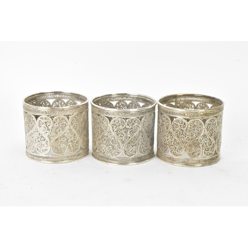 149 - A set of six early 20th century Middle Eastern white metal filigree napkin rings, elaborately pierce... 