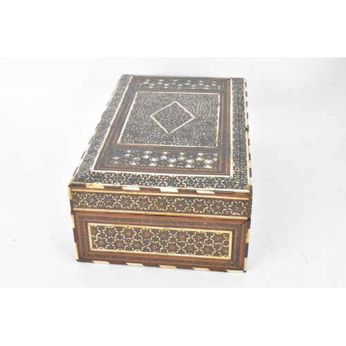 150 - A Persian late Qajar dynasty ink blotter and rectangular formed cigarette box, both profusely decora... 