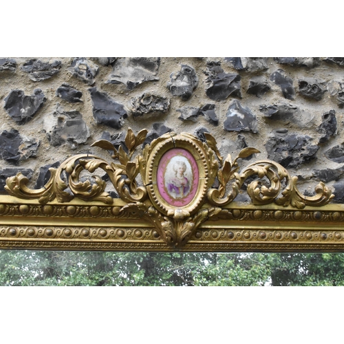 152 - A 19th century French Louis XVI style large gilt wall mirror, having a sevres style painted plaque d... 