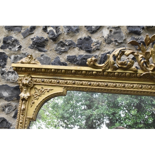 152 - A 19th century French Louis XVI style large gilt wall mirror, having a sevres style painted plaque d... 