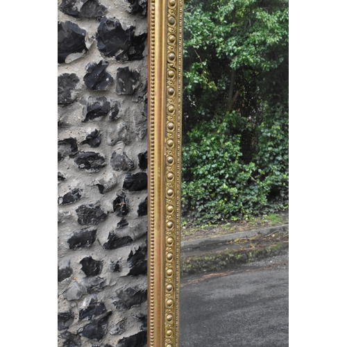 152 - A 19th century French Louis XVI style large gilt wall mirror, having a sevres style painted plaque d... 