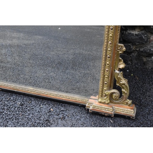 152 - A 19th century French Louis XVI style large gilt wall mirror, having a sevres style painted plaque d... 