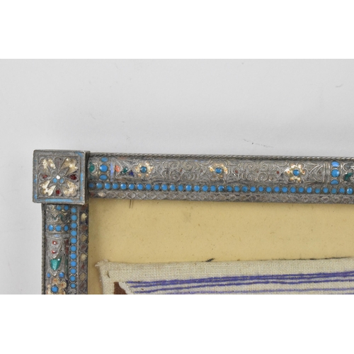 153 - A Russian silver early 20th century champleve enamel photograph frame, inset with a tapestry and bor... 