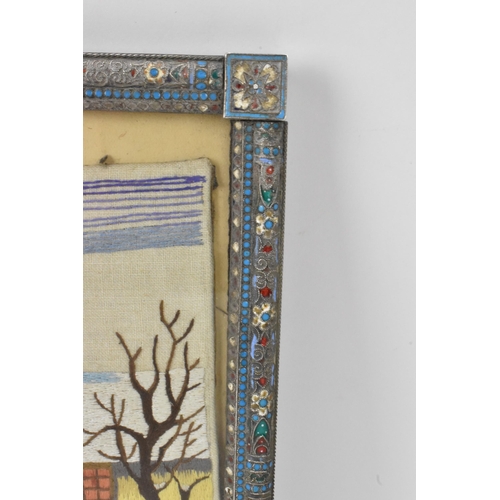 153 - A Russian silver early 20th century champleve enamel photograph frame, inset with a tapestry and bor... 