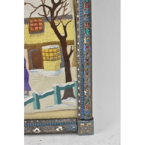 153 - A Russian silver early 20th century champleve enamel photograph frame, inset with a tapestry and bor... 