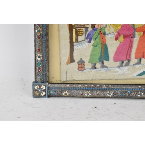 153 - A Russian silver early 20th century champleve enamel photograph frame, inset with a tapestry and bor... 