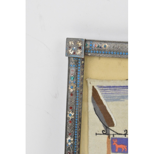 153 - A Russian silver early 20th century champleve enamel photograph frame, inset with a tapestry and bor... 