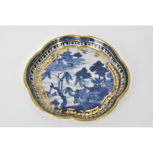 17 - A Chinese export Qing dynasty blue and white teapot and stand, late 18th century, decorated with bui... 