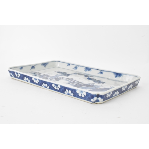 18 - A 19th century Chinese blue and white tray, of rectangular shape and painted with a scene of two fig... 