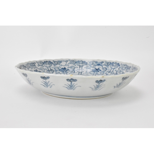 2 - A pair of Qing Dynasty blue and white dishes, with fluted sides and barbed rim, decorated on the int... 