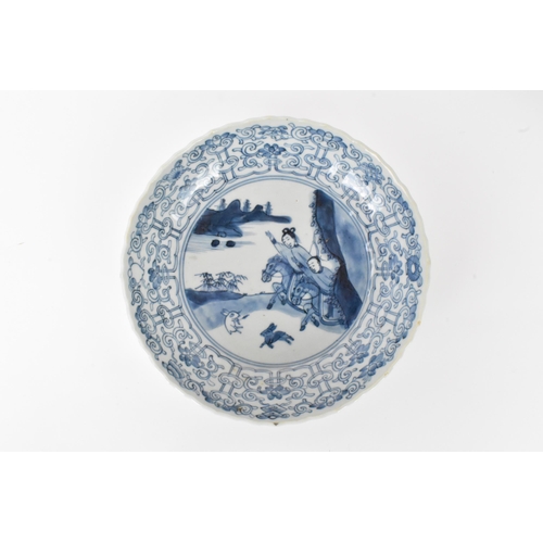 2 - A pair of Qing Dynasty blue and white dishes, with fluted sides and barbed rim, decorated on the int... 