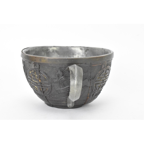 20 - A Chinese late 19th/early 20th century coconut carved cup and saucer, both with pewter liners and th... 