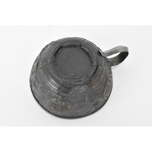 20 - A Chinese late 19th/early 20th century coconut carved cup and saucer, both with pewter liners and th... 