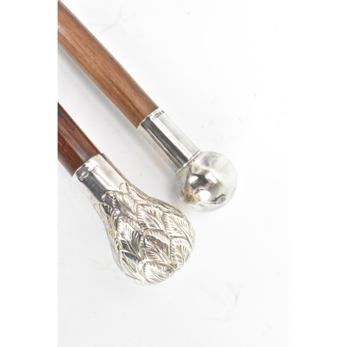 218 - Two mid 20th century silver topped walking sticks, one having a ball knopped finial, hallmarked Birm... 