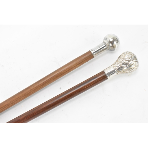 218 - Two mid 20th century silver topped walking sticks, one having a ball knopped finial, hallmarked Birm... 