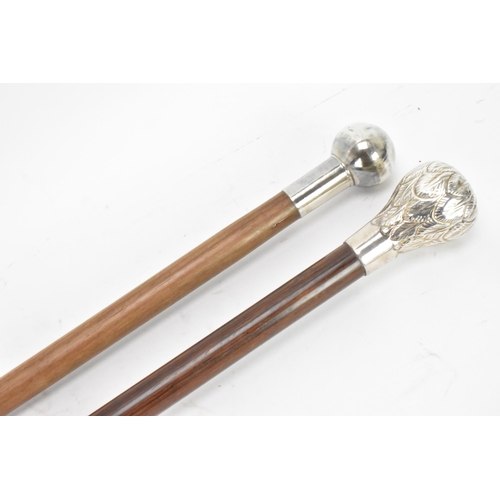 218 - Two mid 20th century silver topped walking sticks, one having a ball knopped finial, hallmarked Birm... 