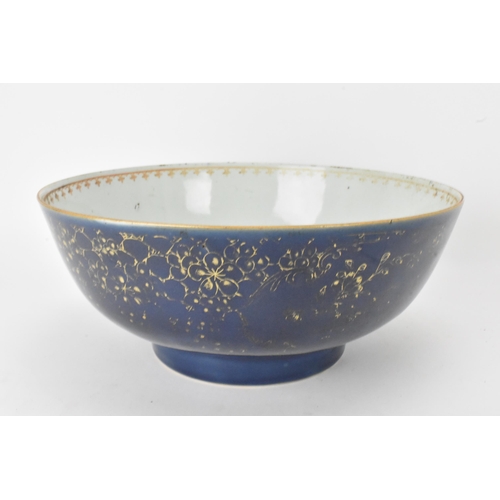 26 - A large Chinese export Qianlong footed bowl, in a powder blue glaze and decorated with gilt flora to... 