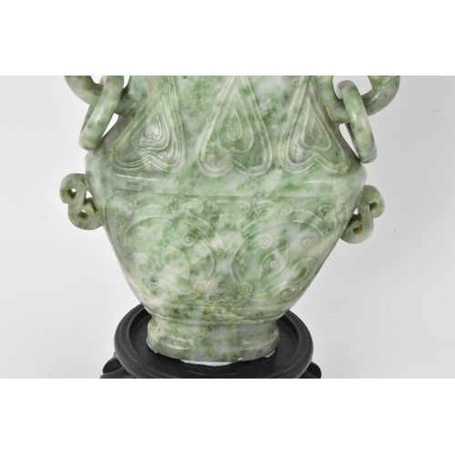 32 - A Chinese 20th century jadeite vase, of flattened baluster shape with archaistic relief decoration, ... 