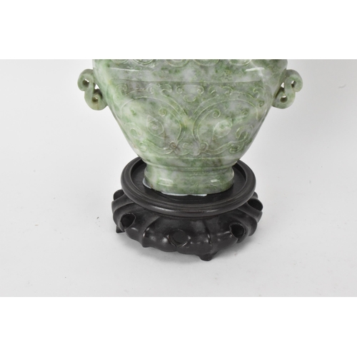 32 - A Chinese 20th century jadeite vase, of flattened baluster shape with archaistic relief decoration, ... 