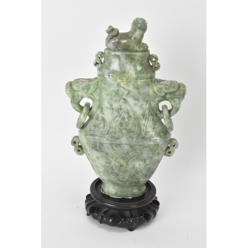 32 - A Chinese 20th century jadeite vase, of flattened baluster shape with archaistic relief decoration, ... 