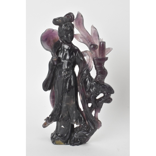 34 - Two Chinese 20th century jadeite carved figures, the green example modeled holding a fan and flowers... 