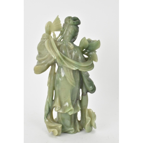 34 - Two Chinese 20th century jadeite carved figures, the green example modeled holding a fan and flowers... 