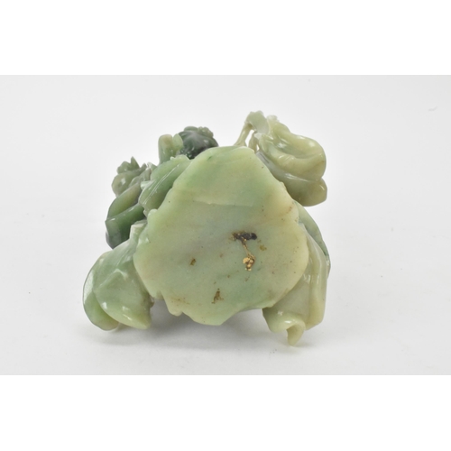 34 - Two Chinese 20th century jadeite carved figures, the green example modeled holding a fan and flowers... 