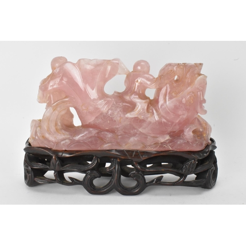 35 - A Chinese 20th century rose quartz figural group of children in a nautical setting riding a sea serp... 