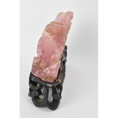 35 - A Chinese 20th century rose quartz figural group of children in a nautical setting riding a sea serp... 