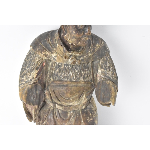 46 - A Chinese carved and painted wood figure of a warrior, late Ming/Qing dynasty, in traditional clothi... 