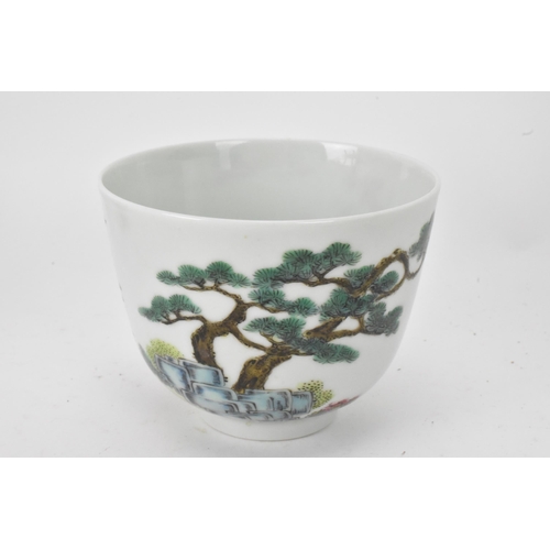 51 - Three Chinese 20th century famille rose tea bowls to include one decorated with figures seated round... 