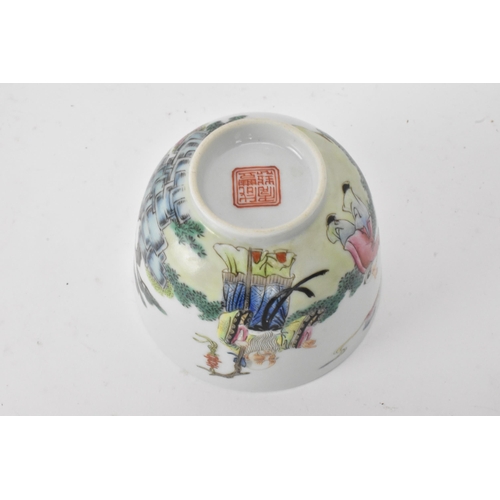 51 - Three Chinese 20th century famille rose tea bowls to include one decorated with figures seated round... 