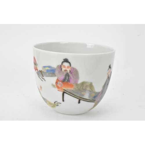 51 - Three Chinese 20th century famille rose tea bowls to include one decorated with figures seated round... 