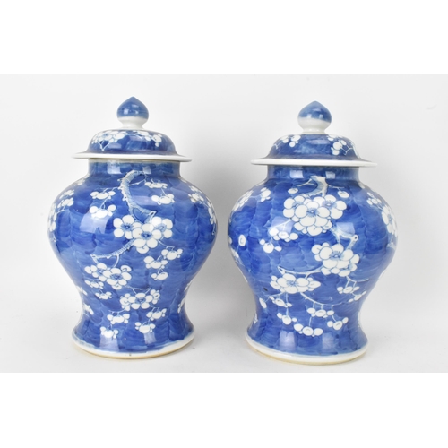 55 - A pair of Chinese prunus pattern blue and white vases, late Qing Dynasty, both of baluster form with... 