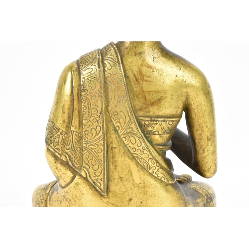 60 - A Sino Tibetian gilt bronze figure of Buddha, 18th/19th century, dressed in monastic robe, with hand... 