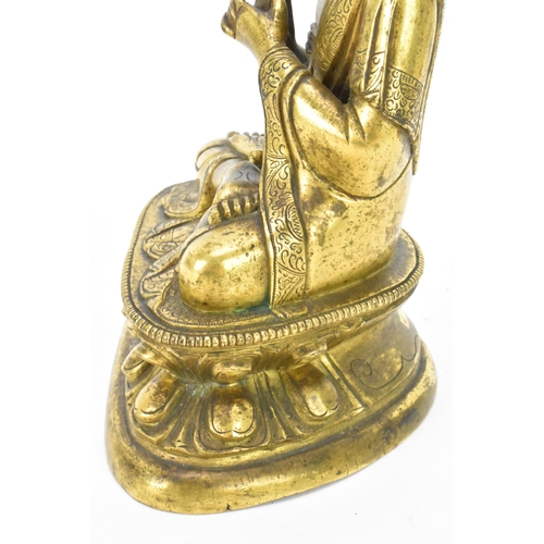 60 - A Sino Tibetian gilt bronze figure of Buddha, 18th/19th century, dressed in monastic robe, with hand... 