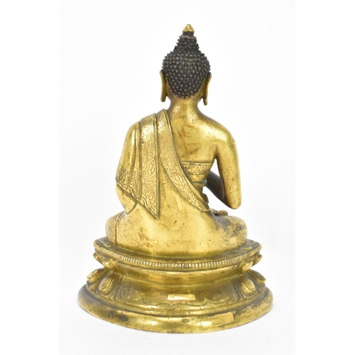 60 - A Sino Tibetian gilt bronze figure of Buddha, 18th/19th century, dressed in monastic robe, with hand... 