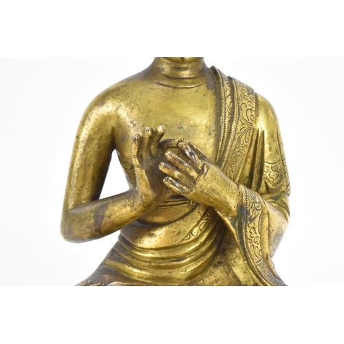 60 - A Sino Tibetian gilt bronze figure of Buddha, 18th/19th century, dressed in monastic robe, with hand... 