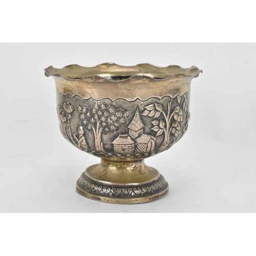 63 - An early 20th century Anglo-Indian white metal bowl, having a crimped rim and embossed decoration de... 