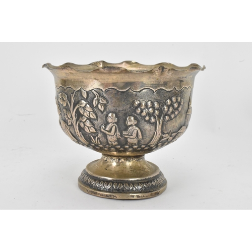 63 - An early 20th century Anglo-Indian white metal bowl, having a crimped rim and embossed decoration de... 