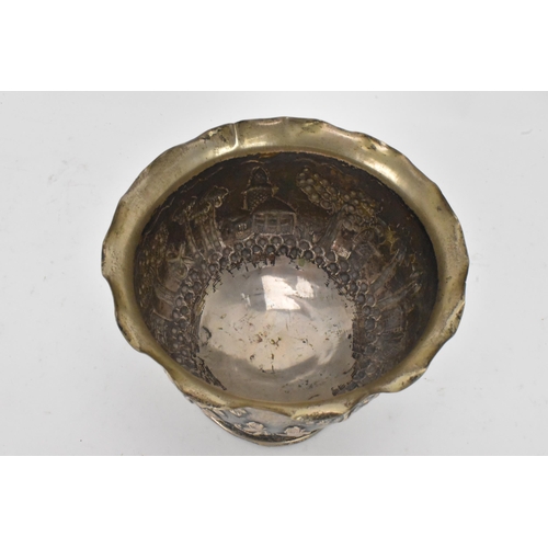 63 - An early 20th century Anglo-Indian white metal bowl, having a crimped rim and embossed decoration de... 