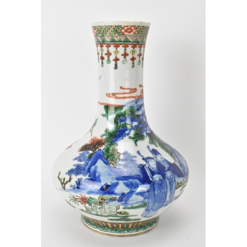 7 - A Chinese Famille Vert bottle neck vase, decorated with figures, horse and butterflies in a landscap... 