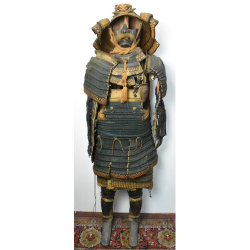 A Japanese Samurai Warriors Set of Dō-maru style Armour fitted with menpo facial armour, a kabuto helmet with a Fukigaeshi, wing-like or ear-like projections, with sode, gauntlets, thigh protectors and greaves, all mounted on a wooden stand, 170cm high